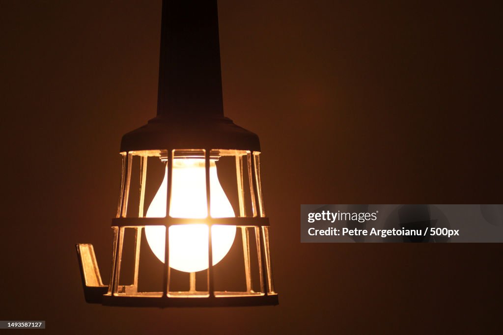 Vintage old bulb in rustic shed light and glows in the dark with copy space