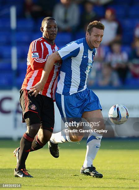 Steve Howard of Hartlepool is tackled by Titus Bramble of Sunderland during the Pre Season Friendly match between Hartlepool and Sunderland at...