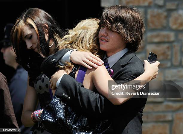 Classmates and friends of shooting victim Alexander Jonathan "A.J." Boik comfort each other after Boik's funeral at Queen of Peace Catholic Church...