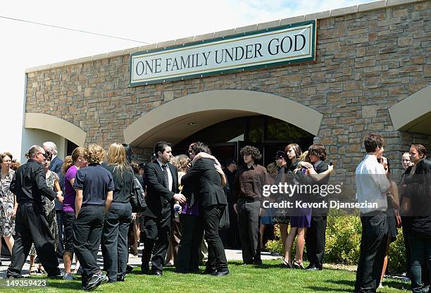 Classmates, friends and family of shooting victim Alexander Jonathan "A.J." Boik comfort each other after Boik's funeral at Queen of Peace Catholic...