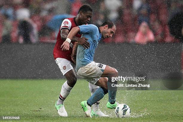 Chuks Aneke of Arsenal FC challenges Pablo Zabaleta of Manchester City during the pre-season Asian Tour friendly match between Arsenal and Manchester...