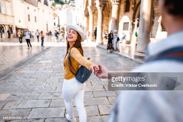 young tourist couple having fun exploring the city - croatia people stock pictures, royalty-free photos & images