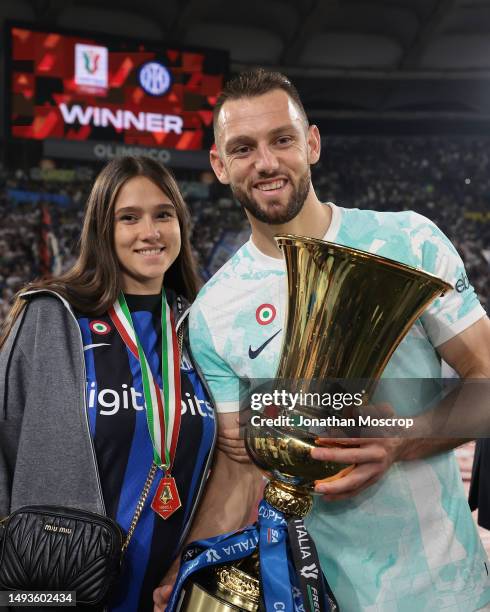 Stefan de Vrij of FC Internazionale and his partner Doina Turcanu pose with the trophy following the 2-1 victory in the Coppa Italia Final match...