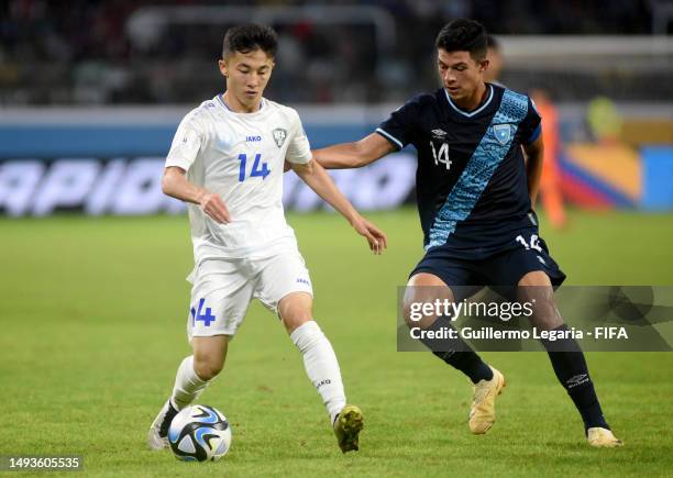 Abbosbek Fayzullaev of Uzbekistan and Jonathan Franco of Guatemala battle for the ball during a FIFA U-20 World Cup Argentina 2023 Group B match...