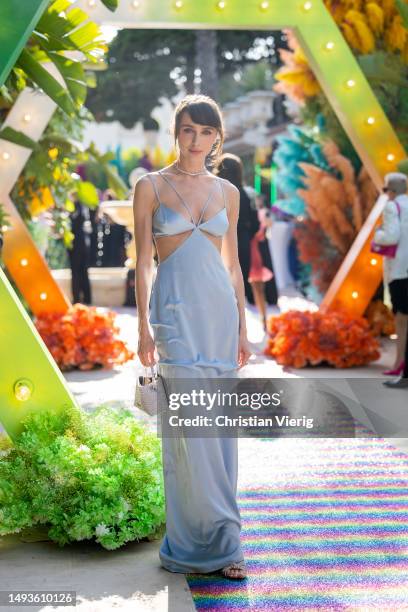 Mary Leest wears blue cut out satin dress, silver bag at Philipp Plein show during the 76th Cannes film festival on May 26, 2023 in Cannes, France.