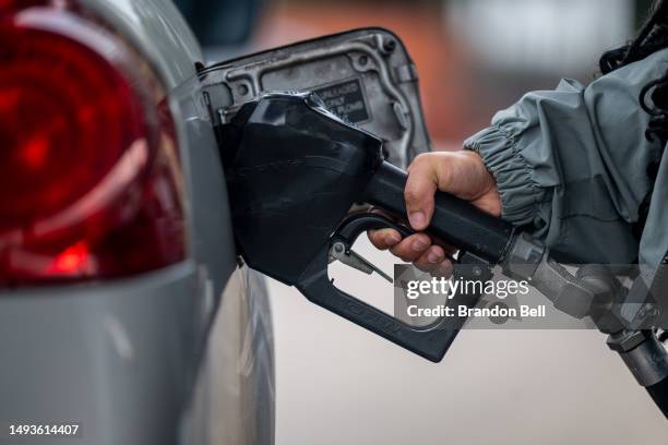 Person pumps gas at a Chevron gas station on May 26, 2023 in Austin, Texas. Millions of Americans are expected to travel this Memorial Day Weekend as...