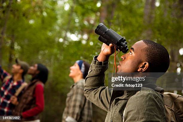 group of friends camping and hiking using binoculars. bird watching. - viewing binoculars stock pictures, royalty-free photos & images