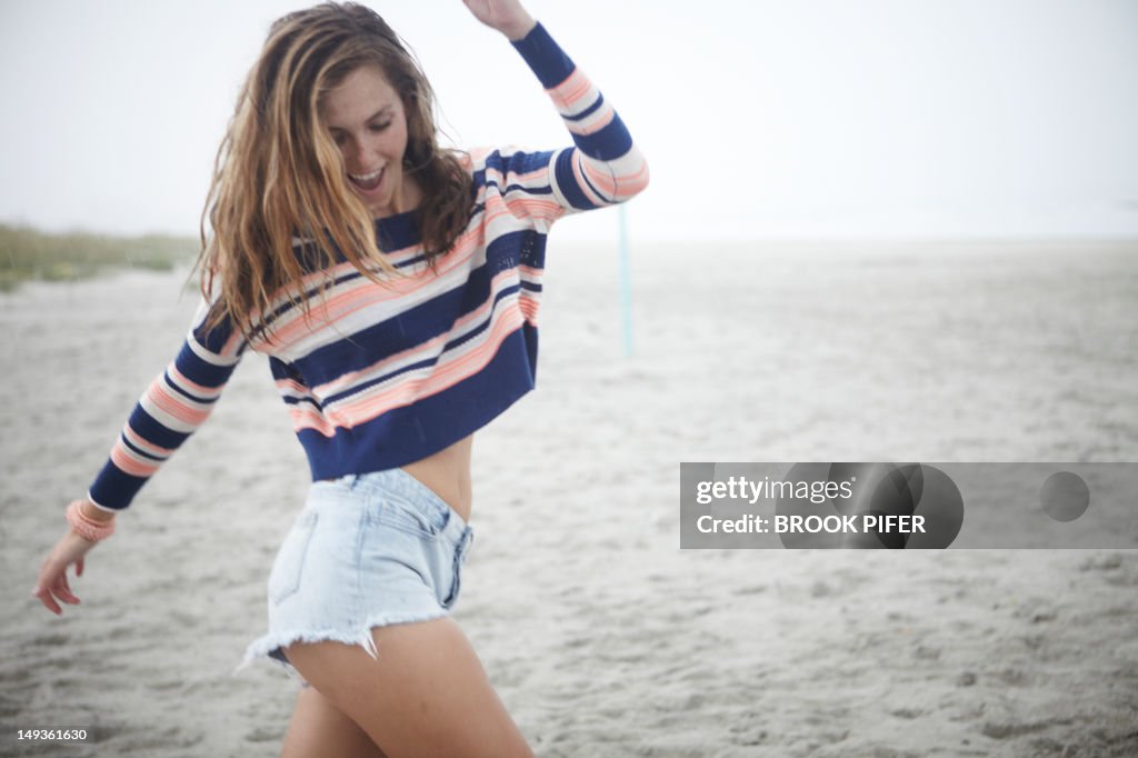 Young woman dancing on beach