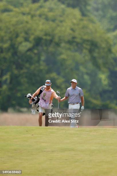 Spencer Cross of the United States hands a club to his caddie on the third hole during the second round of the Visit Knoxville Open at Holston Hills...