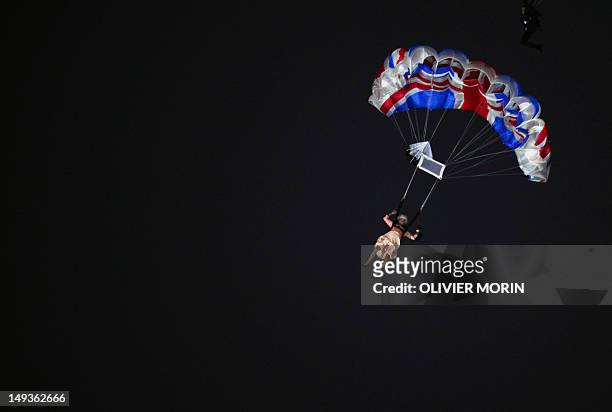 An actor dressed to resemble Britain's Queen Elizabeth II parachutes into the stadium during the opening ceremony of the London 2012 Olympic Games at...