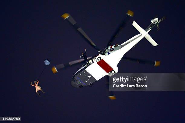 Performer in the role of Queen Elizabeth II parachutes out of a helicopter hovering above the stadium during the Opening Ceremony of the London 2012...