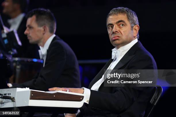 British actor Rowan Atkinson in his role as Mr Bean takes part in the Opening Ceremony of the London 2012 Olympic Games at the Olympic Stadium on...