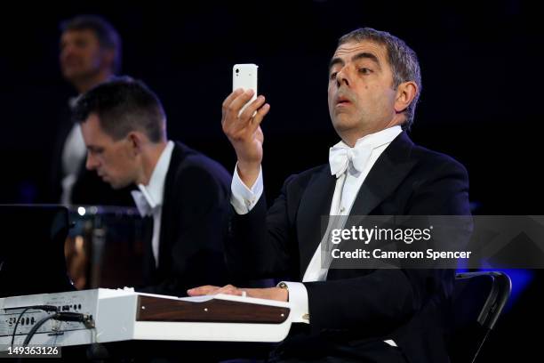 British actor Rowan Atkinson in his role as Mr Bean takes part in the Opening Ceremony of the London 2012 Olympic Games at the Olympic Stadium on...