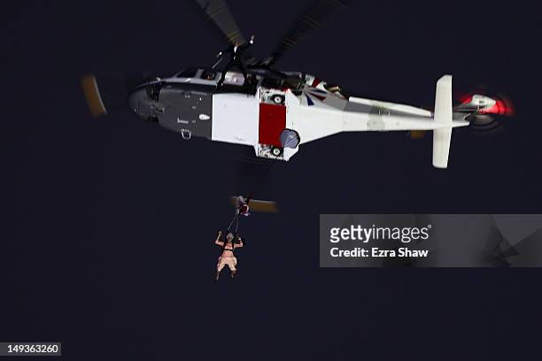 Person dressed as Queen Elizabeth II parachutes into the Olympic stadium during the Opening Ceremony of the London 2012 Olympic Games at the Olympic...