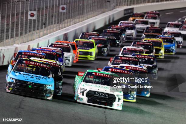 Corey Heim, driver of the Rootly Toyota, and Carson Hocevar, driver of the Worldwide Express Chevrolet, lead the field to a restart during the NASCAR...