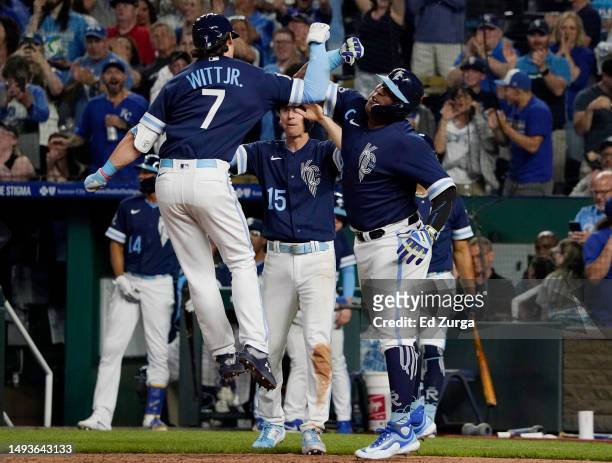 Bobby Witt Jr. #7 of the Kansas City Royals celebrates his three-run home run with Salvador Perez and Matt Duffy in the seventh inning against the...