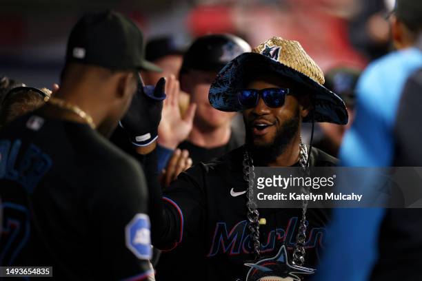 Bryan De La Cruz of the Miami Marlins celebrates with teammates in the dugout after his two run home run during the seventh inning against the Los...
