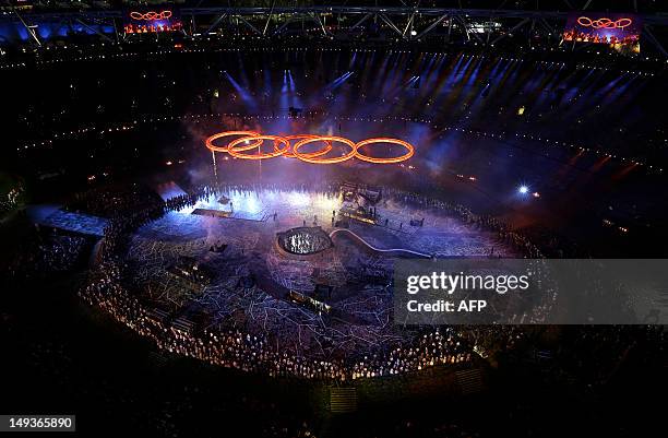The Olympic rings light up Olympic Stadium during the Opening Ceremony of the 2012 London Olympic Games on July 27, 2012 in London. AFP PHOTO / Pool...