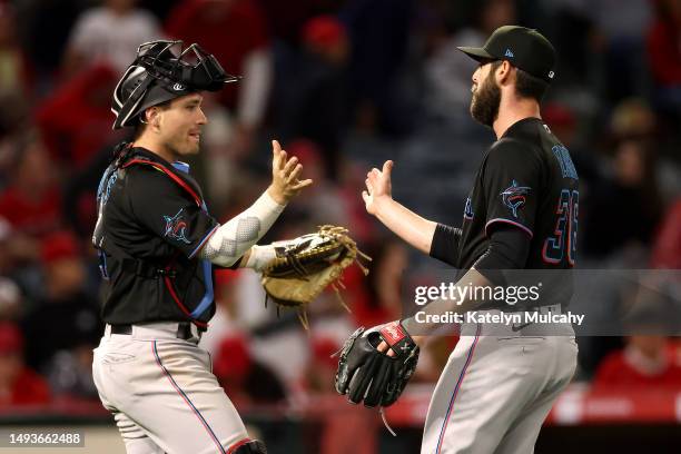 Nick Fortes and Dylan Floro of the Miami Marlins celebrate after their 6-2 win against the Los Angeles Angels at Angel Stadium of Anaheim on May 26,...