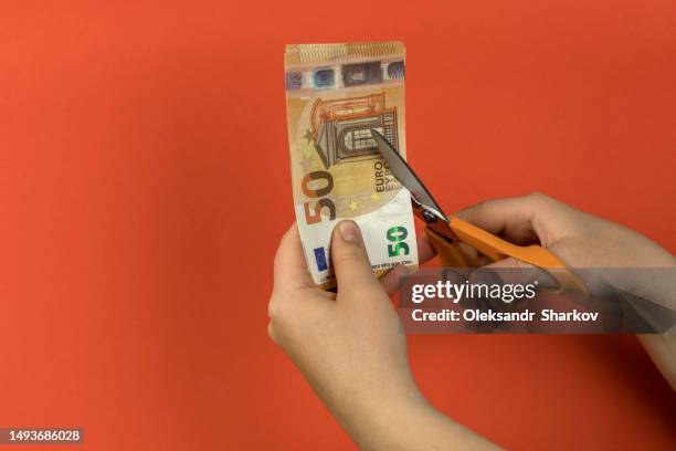 cutting the cost of inflation - monetary policy stock pictures, royalty-free photos & images