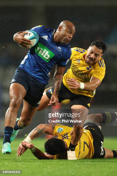 Mark Telea of the Blues is tackledduring the round 14 Super Rugby Pacific match between Blues and Hurricanes at Eden Park, on May 27 in Auckland, New...