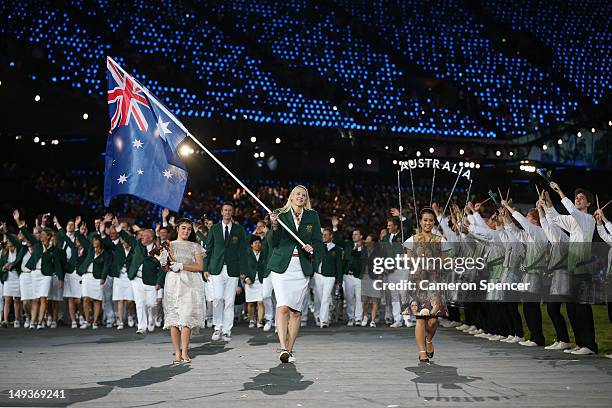 Lauren Jackson of the Australian Olympic basketball team carries her country's flag as she leads the Australian team into the stadium during the...