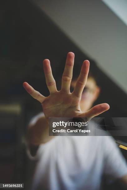 young male teenager  open palm.stop gesture - spain teen face imagens e fotografias de stock