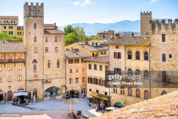 a cityscape of the medieval town of arezzo in tuscany seen from the rooftops of the piazza grande - arezzo stock pictures, royalty-free photos & images