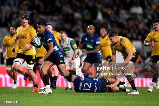 Rieko Ioane of the Blues makes a break to score a try during the round 14 Super Rugby Pacific match between Blues and Hurricanes at Eden Park, on May...