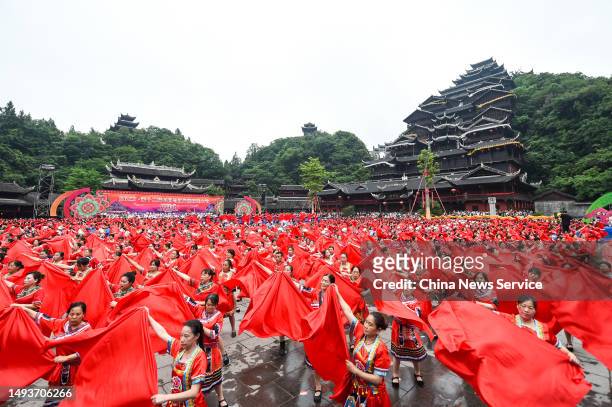 Miao people in traditional costumes dance during the 12th China Wujiang Miao Caihuashan Festival, also known as the Valentine's Day of the Miao...