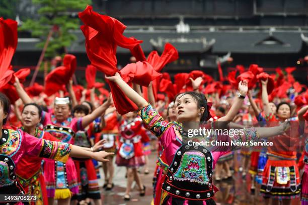 Miao people in traditional costumes dance during the 12th China Wujiang Miao Caihuashan Festival, also known as the Valentine's Day of the Miao...