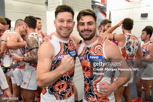 Toby Greene and Stephen Coniglio of the Giants pose for a photo whilst celebrating victory in Greene's 200th match during the round 11 AFL match...
