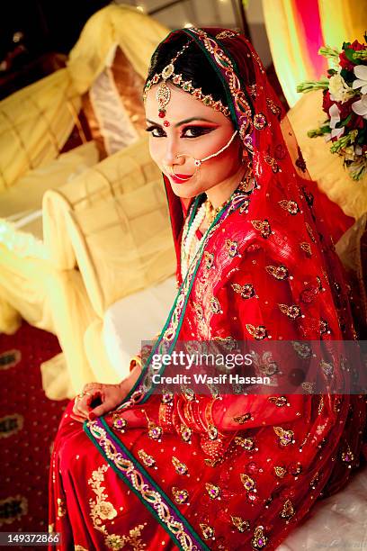 beautiful bride sitting - indian bridal makeup stock pictures, royalty-free photos & images