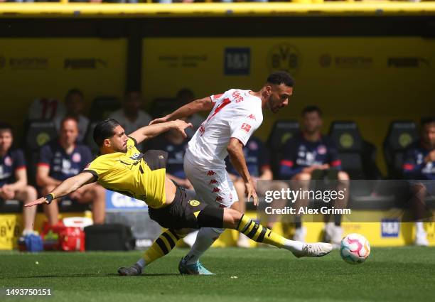 Emre Can of Borussia Dortmund battles for possession with Karim Onisiwo of 1.FSV Mainz 05 during the Bundesliga match between Borussia Dortmund and...