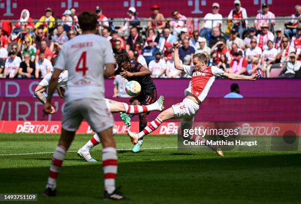 Kingsley Coman of FC Bayern Munich scores the team's first goal during the Bundesliga match between 1. FC Köln and FC Bayern München at...