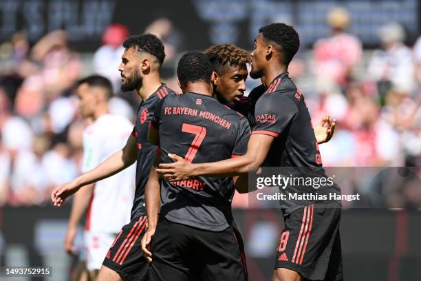 Kingsley Coman of FC Bayern Munich celebrates with teammates after scoring the team's first goal during the Bundesliga match between 1. FC Köln and...