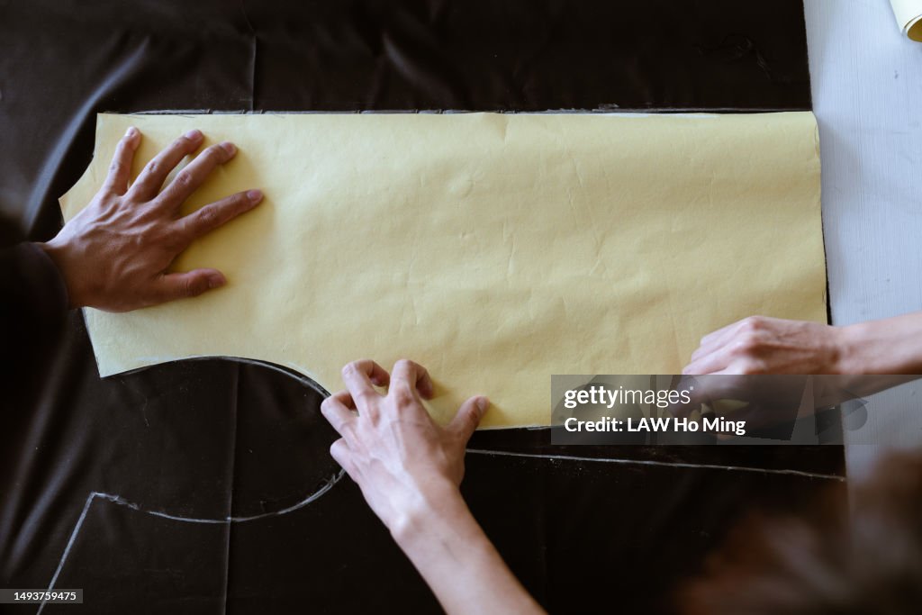 Close-up of fabric being cut according to the design pattern