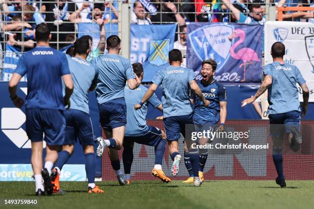 Takuma Asano of Bochum celebrates the second goal with his team matey during the Bundesliga match between VfL Bochum 1848 and Bayer 04 Leverkusen at...