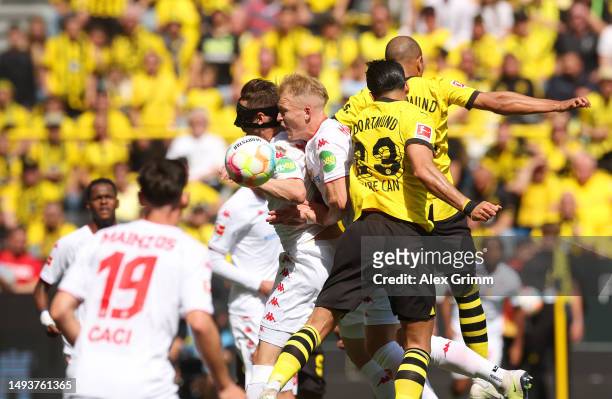 Emre Can and Donyell Malen of Borussia Dortmund jumps for the ball with Dominik Kohr and Andreas Hanche-Olsen of 1.FSV Mainz 05 during the Bundesliga...