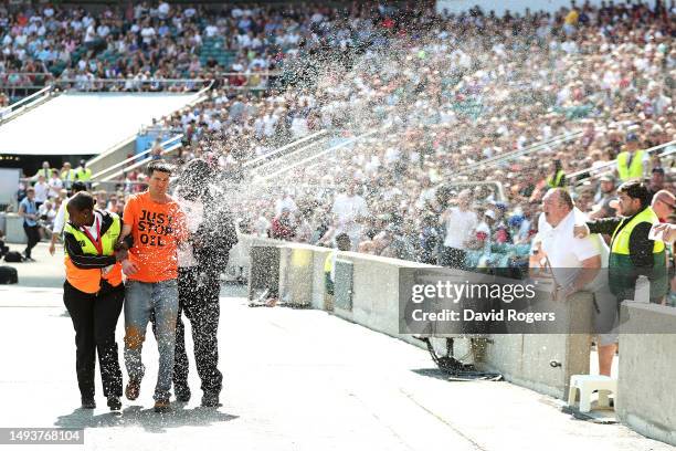 Just Stop Oil' protestor invades the pitch and is apprehended by stewards during the Gallagher Premiership Final between Saracens and Sale Sharks at...