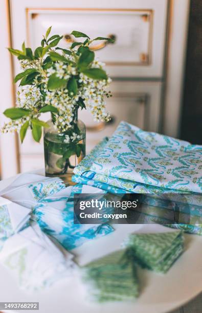 quilting sewing accessories, patchwork square spring block fragment of quilt. patchwork green blue white block quilt, sewing accessories, fabrics on white background. flat lay - patchwork quilt stock pictures, royalty-free photos & images