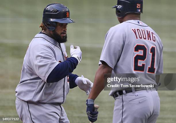 Prince Fielder of the Detroit Tigers is congratulated by Delmon Young after hitting a solo home run in the 1st inning during MLB game action against...