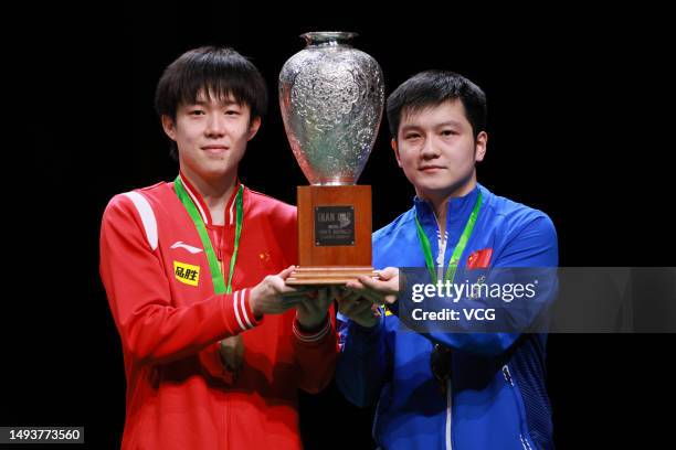 Gold medalists Wang Chuqin and Fan Zhendong of China pose with the trophy during medal ceremony for the Men's Doubles final match on day 8 of World...