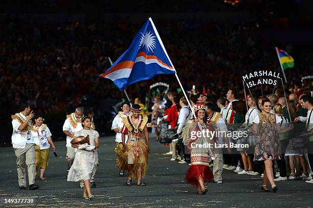 Haley Nemra of the Marshall Islands Olympic athletics team carries her country's flag during the Opening Ceremony of the London 2012 Olympic Games at...