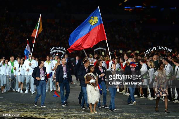 Stephanie Vogt of the Liechtenstein Olympic tennis team carries her country's flag during the Opening Ceremony of the London 2012 Olympic Games at...
