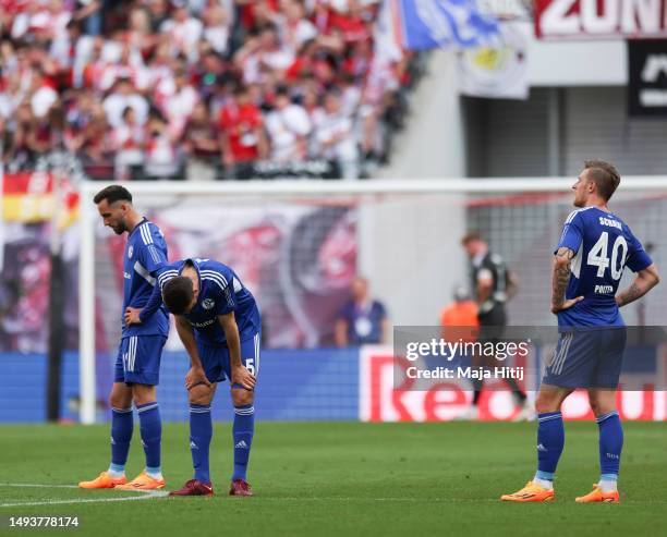 Sepp van den Berg and Sebastian Polter of FC Schalke 04 react after the fourth goal of RB Leipzig scored by Christopher Nkunku during the Bundesliga...