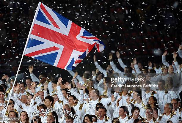 Sir Chris Hoy of the Great Britain Olympic cycling team carries his country's flag during the Opening Ceremony of the London 2012 Olympic Games at...