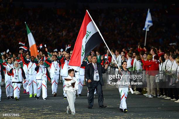 Dana Abdul Razak of the Iraq Olympic athletics team carries her country's flag during the Opening Ceremony of the London 2012 Olympic Games at the...