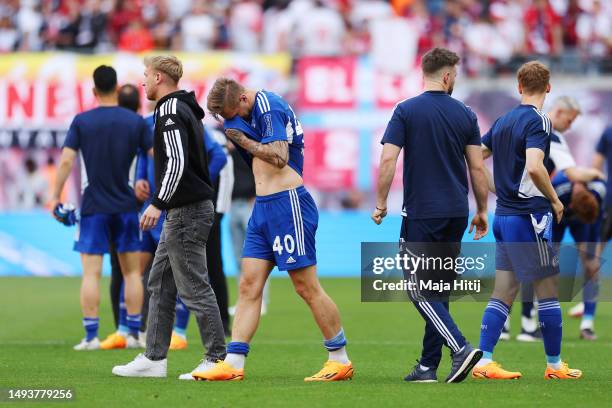 Sebastian Polter of FC Schalke 04 looks dejected after the team's defeat leading to their relegation after the Bundesliga match between RB Leipzig...