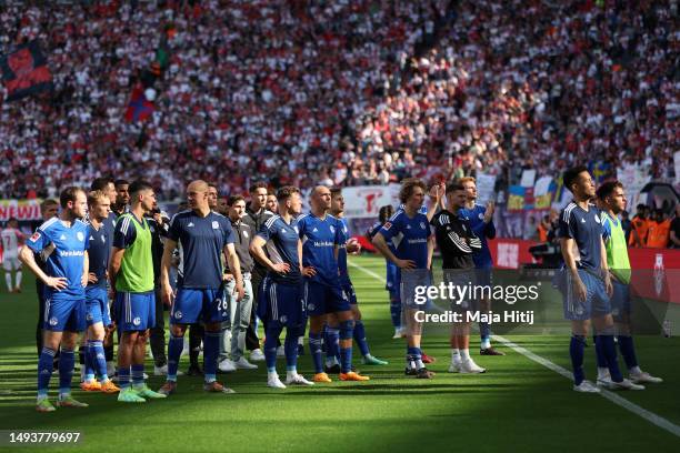 Players of FC Schalke 04, acknowledge the fans after the team's defeat leading to their relegation after the Bundesliga match between RB Leipzig and...